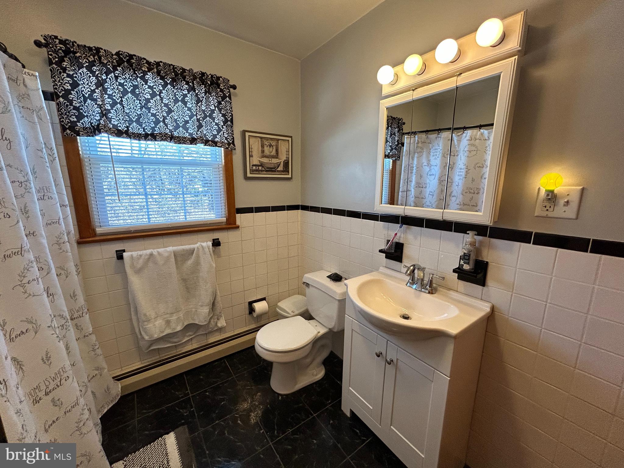 144 Annapolis Road Pennsville, NJ 08070 - Photo 5 of 24 a bathroom with a toilet sink and mirror