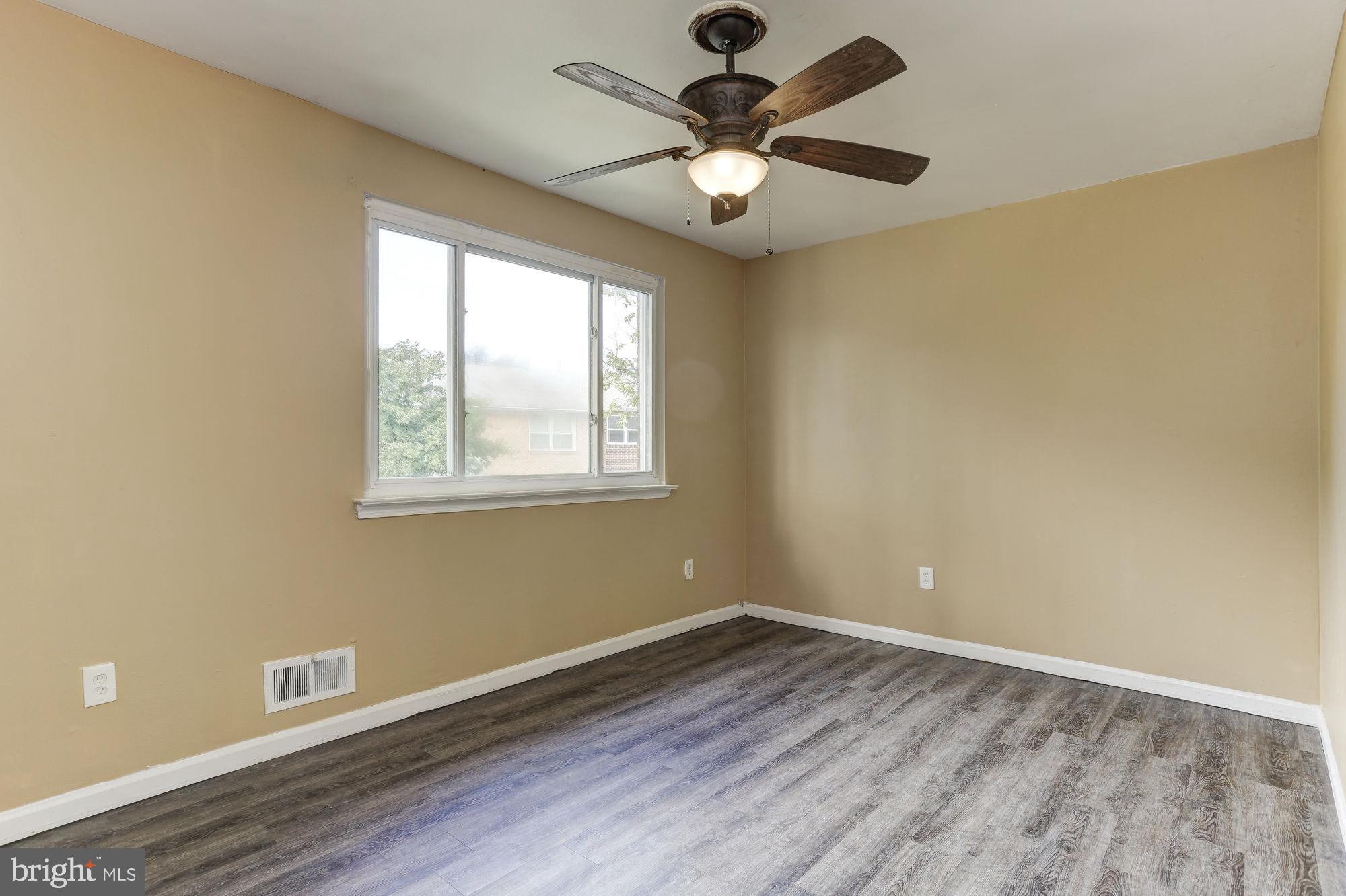 1925 Addison Road South District Heights, MD 20747 - Photo 7 of 9 wooden floor in an empty room with a window