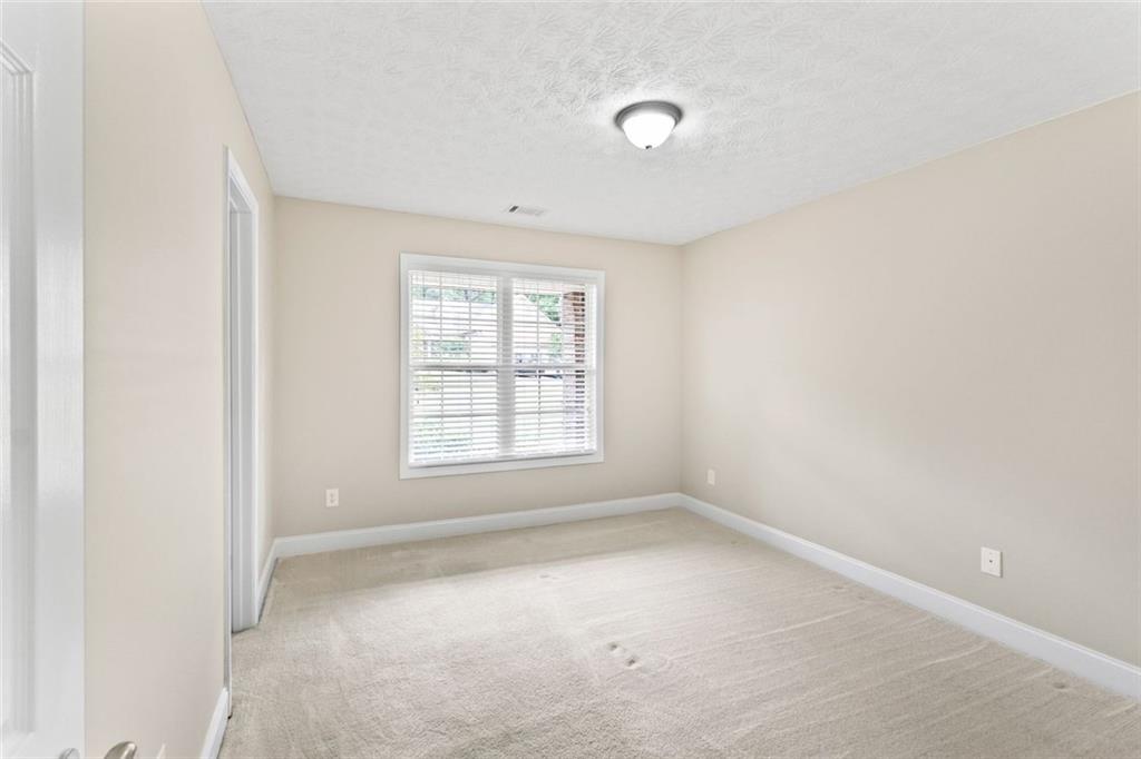241 Red Bud Road Jefferson, GA 30549 - Photo 10 of 43 an empty room with a window