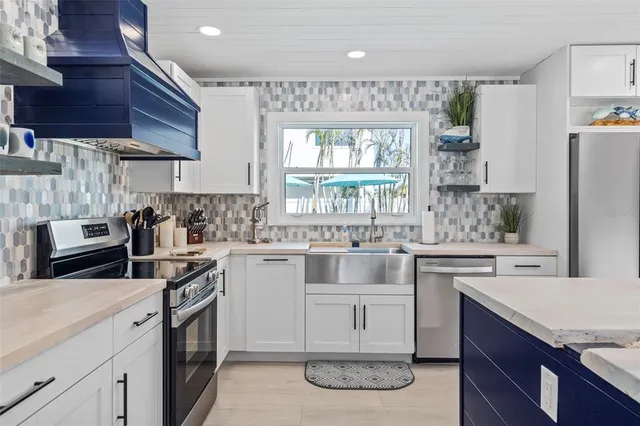 a kitchen with stainless steel appliances granite countertop a stove and a refrigerator