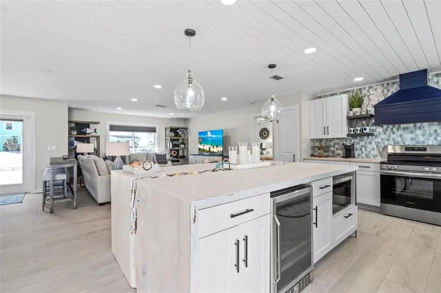 a kitchen with stainless steel appliances kitchen island granite countertop a lot of counter space and a window