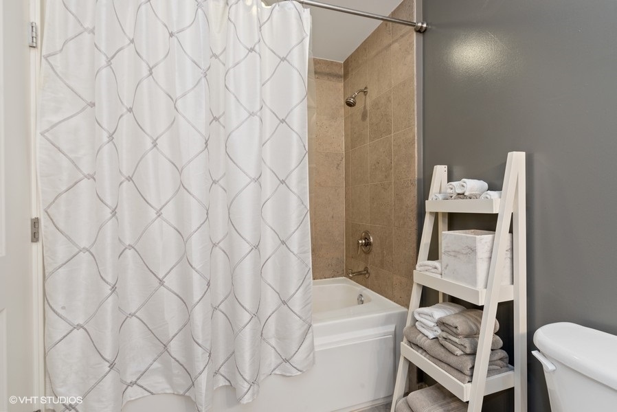 744 North Clark Street, Unit 501 Chicago, IL 60654 - Photo 12 of 16 a bathroom with a sink toilet and shower