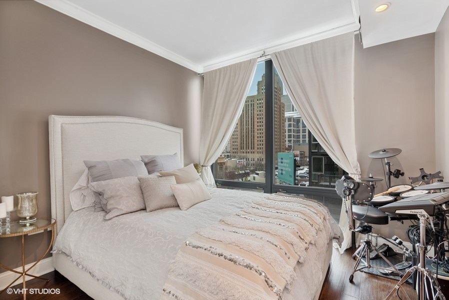 744 North Clark Street, Unit 501 Chicago, IL 60654 - Photo 14 of 16 a bedroom with a bed and a large window