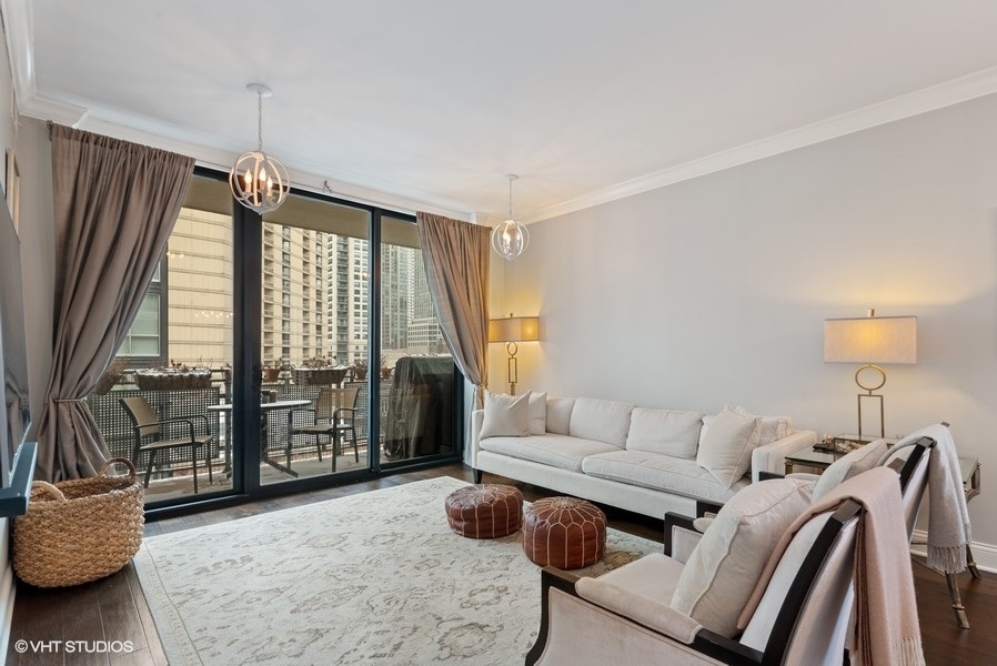 744 North Clark Street, Unit 501 Chicago, IL 60654 - Photo 2 of 16 a living room with furniture and a window