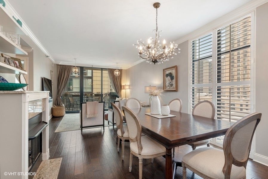 744 North Clark Street, Unit 501 Chicago, IL 60654 - Photo 3 of 16 a view of a dining room with furniture window and wooden floor