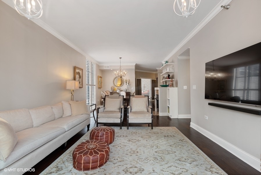 744 North Clark Street, Unit 501 Chicago, IL 60654 - Photo 4 of 16 a living room with furniture and a flat screen tv