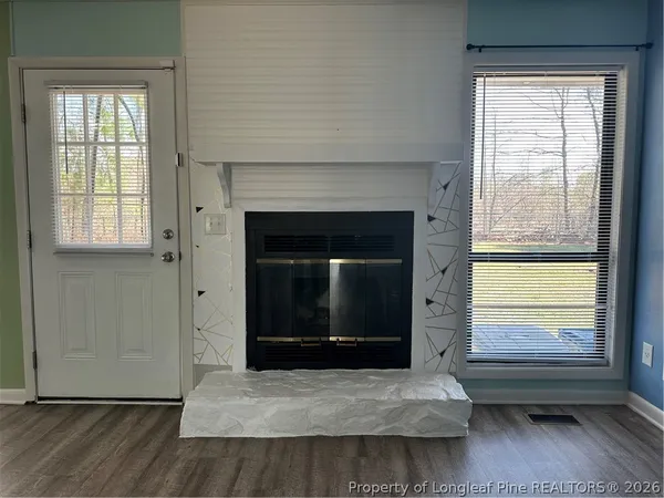 a living room with a fireplace and a window
