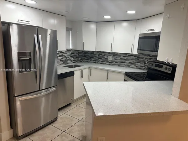 a kitchen with stainless steel appliances a refrigerator and a stove