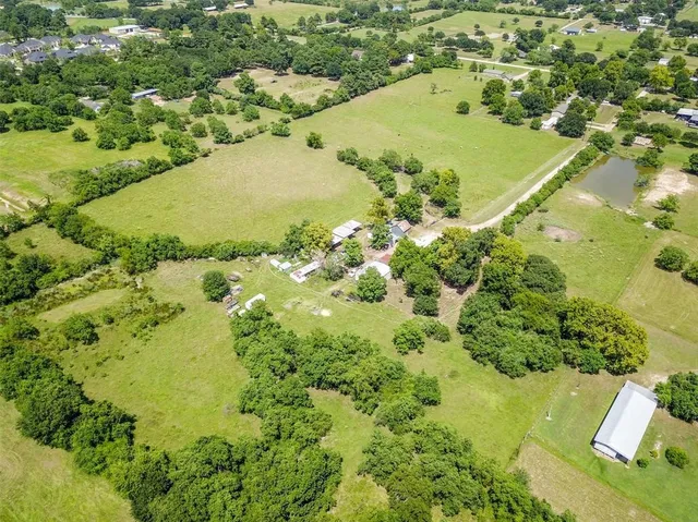 an aerial view of a residential houses with outdoor space