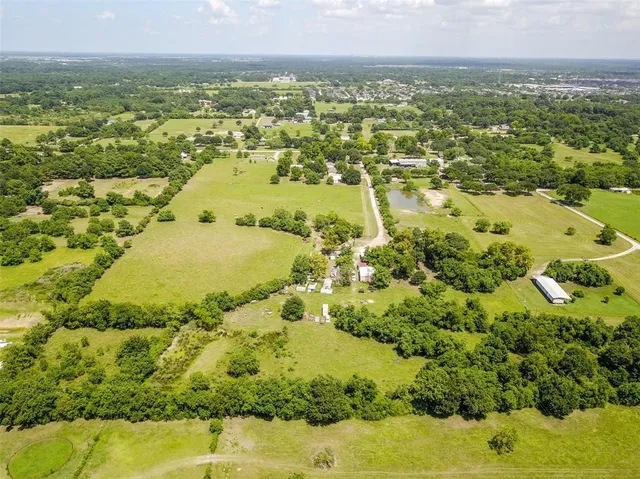 an aerial view of ocean with residential house swimming pool and outdoor space