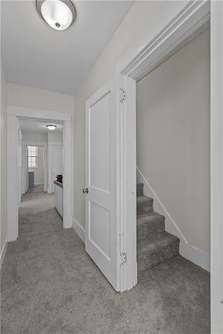 a view of a hallway with wooden shelves