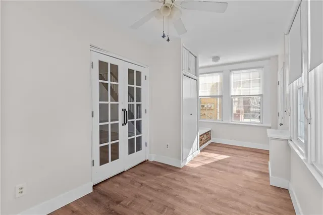 an empty room with windows and entrance