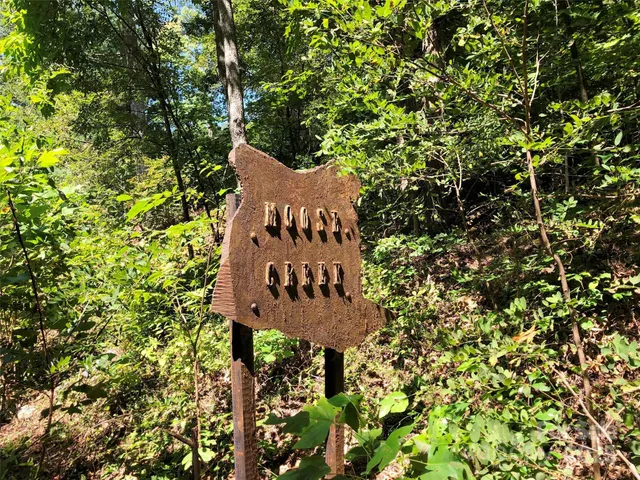 a sign on the side of a tree