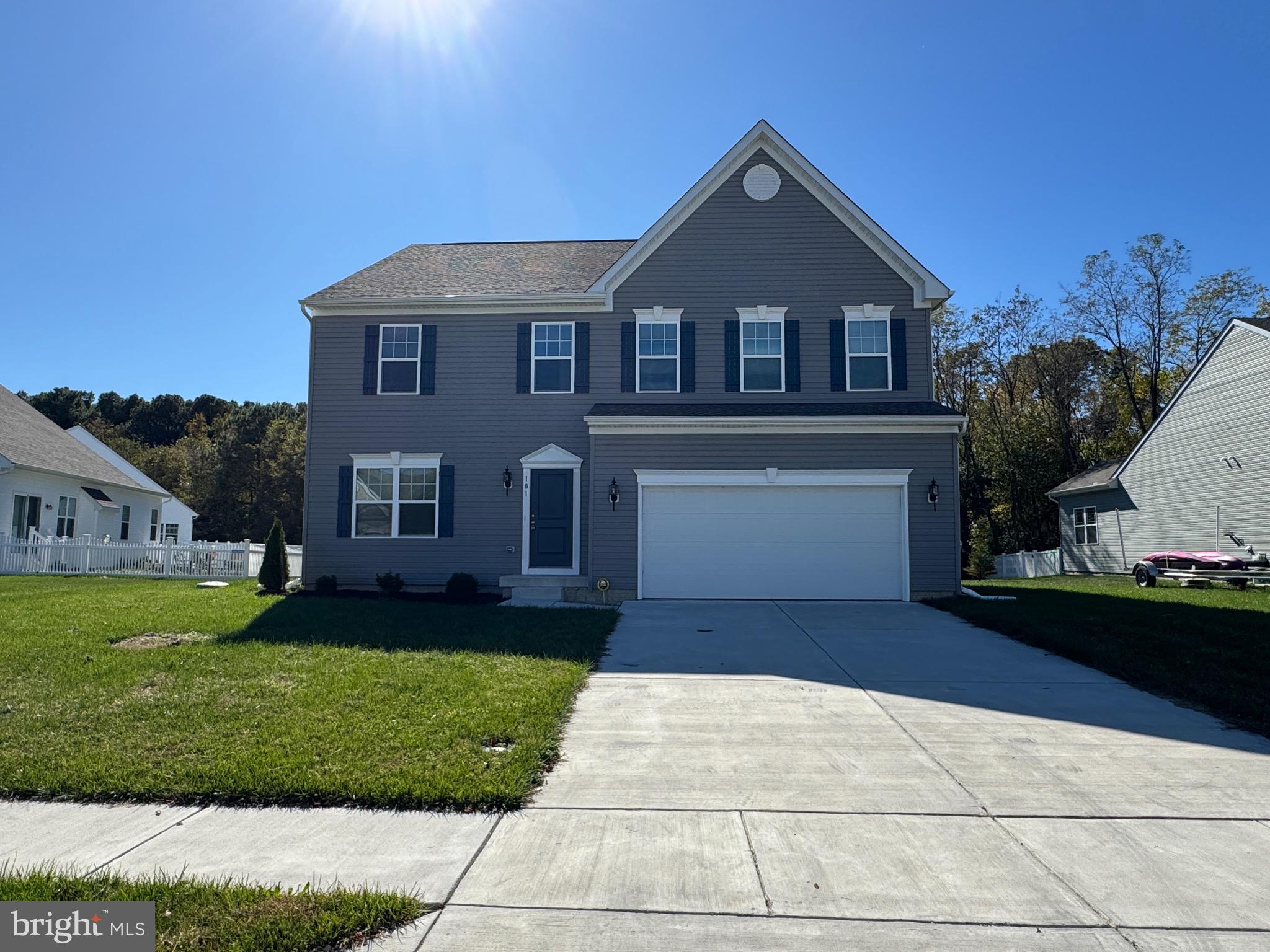 101 Albemarle Court Cambridge, MD 21613 - Photo 6 of 47 a front view of a house with a yard and garage