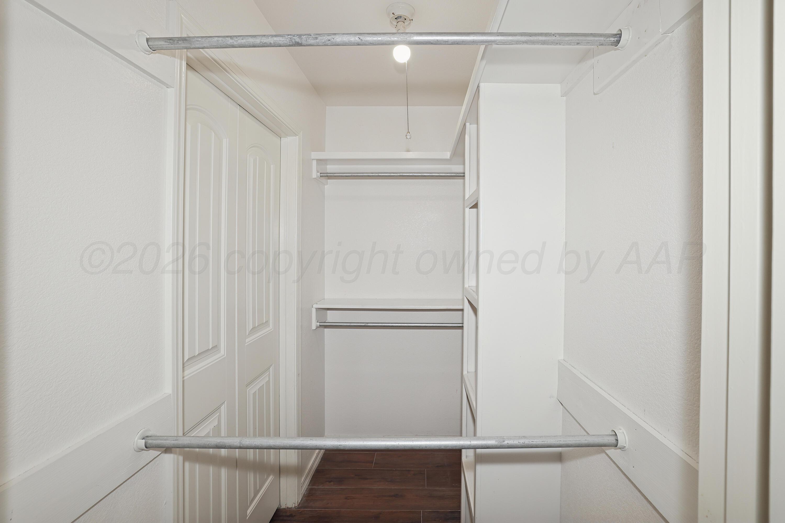 6709 Mosley Street Amarillo, TX 79119 - Photo 24 of 29 a view of walk in closet with empty racks