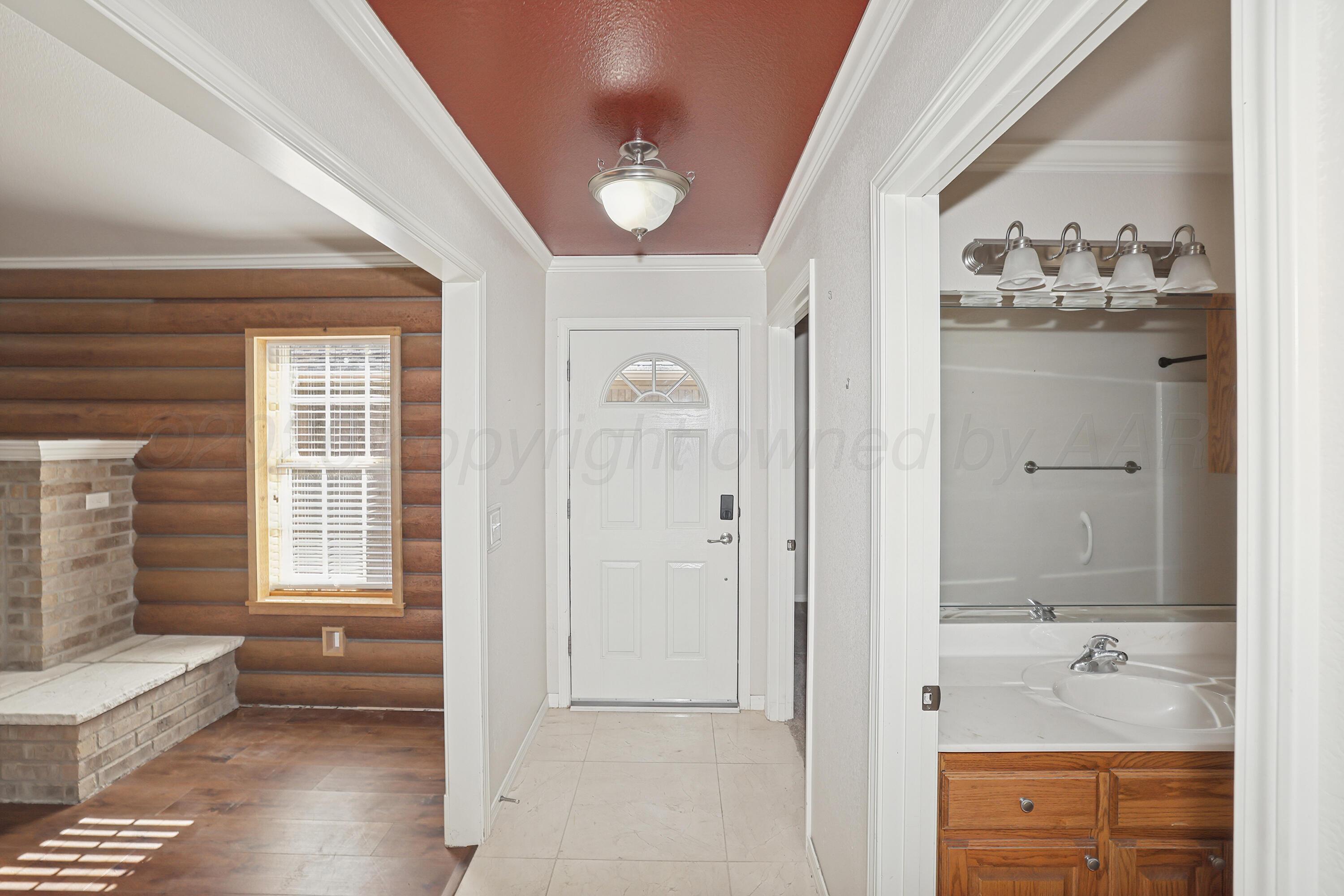6709 Mosley Street Amarillo, TX 79119 - Photo 3 of 29 wooden floor with windows and closet