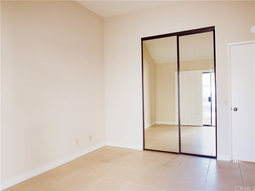 15 Robinsong, Unit 160 Irvine, CA 92614 - Photo 14 of 31 Master bedroom with vaulted ceilings and mirrored wardrobes