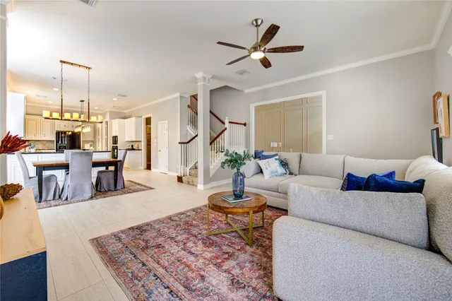 a living room with couches a coffee table and piano table with wooden floor