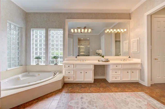 a spacious bathroom with a tub sink and mirror