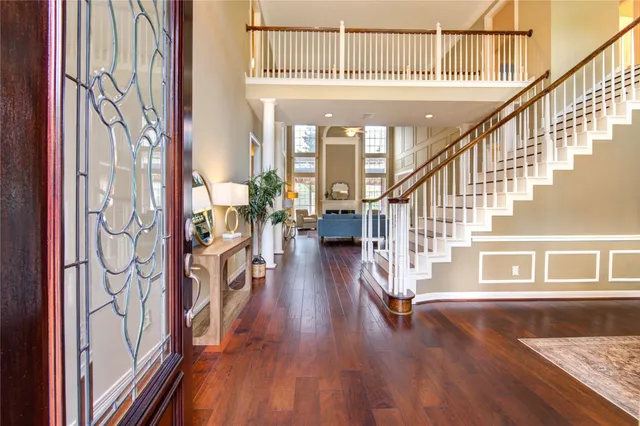 a view of an entryway with wooden floor door and windows