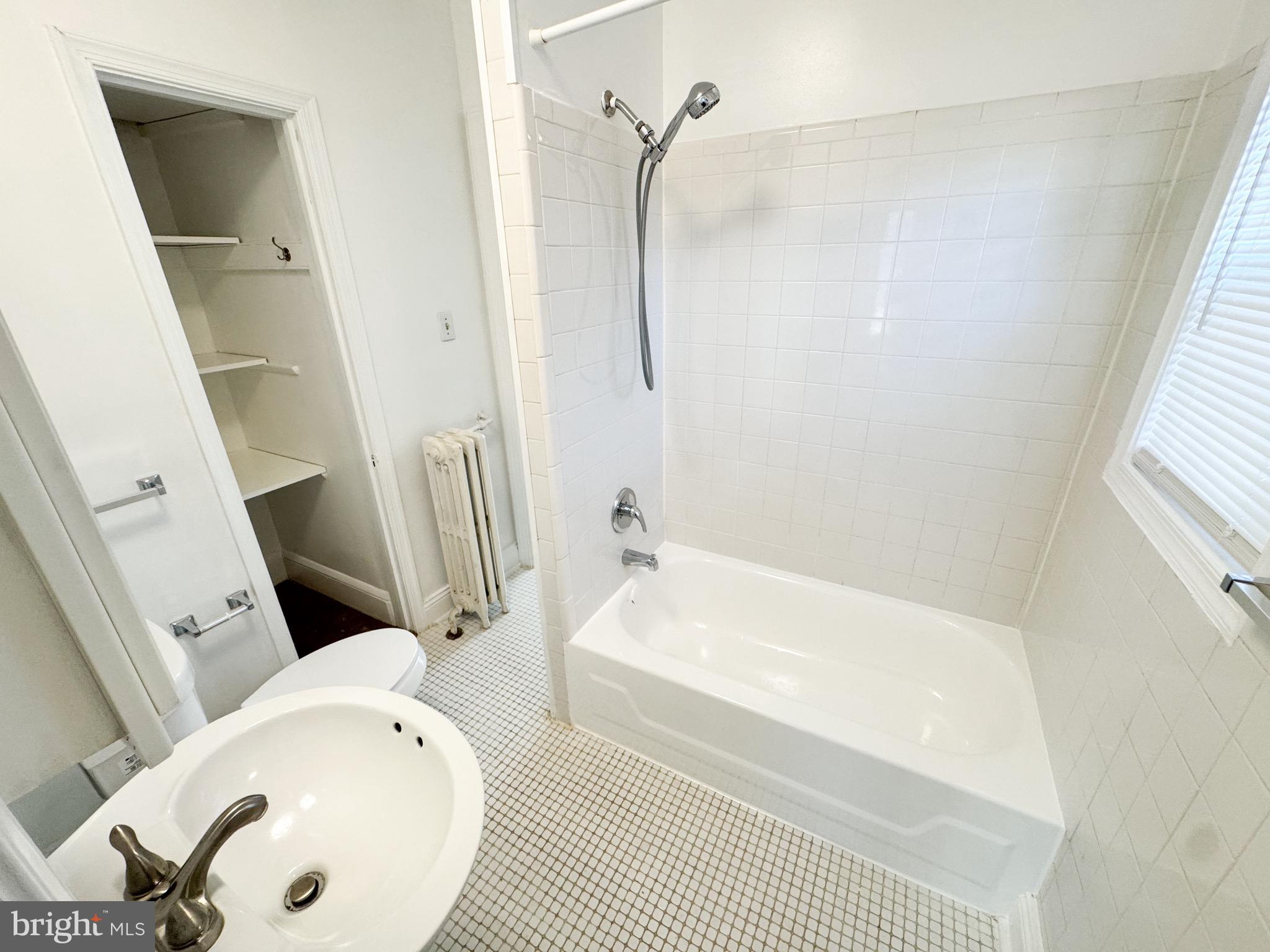 4348 Ellicott Street Northwest, Unit 3 Washington, DC 20016 - Photo 6 of 16 a bathroom with a tub and a shower