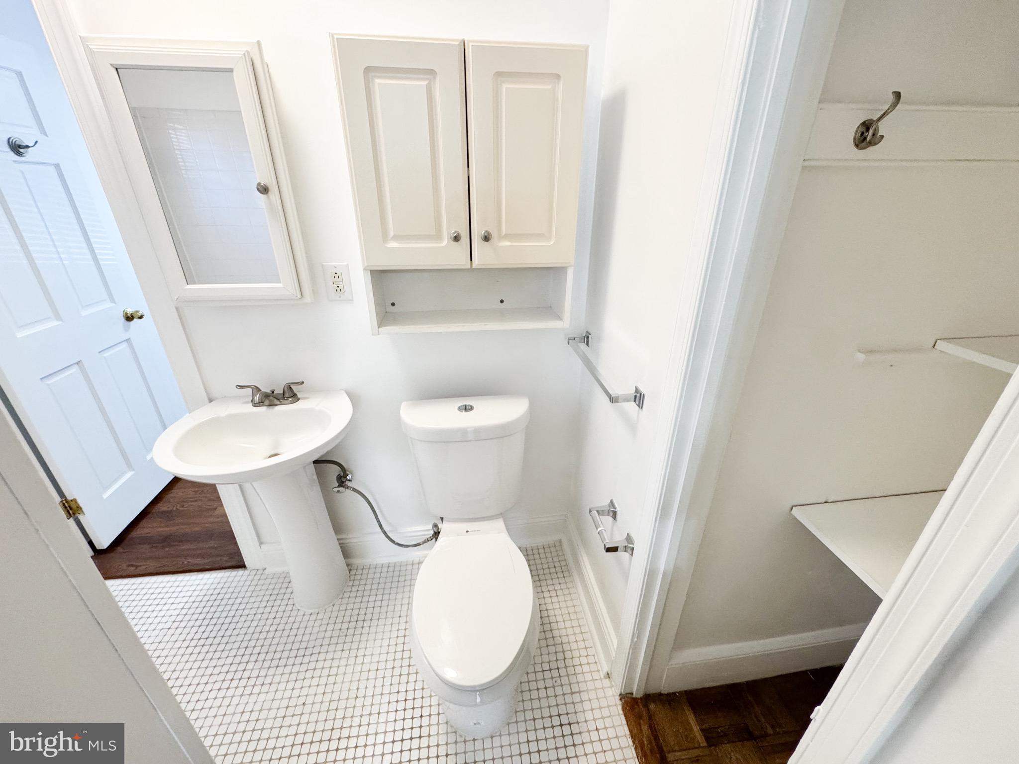 4348 Ellicott Street Northwest, Unit 3 Washington, DC 20016 - Photo 7 of 16 a bathroom with a sink and a mirror