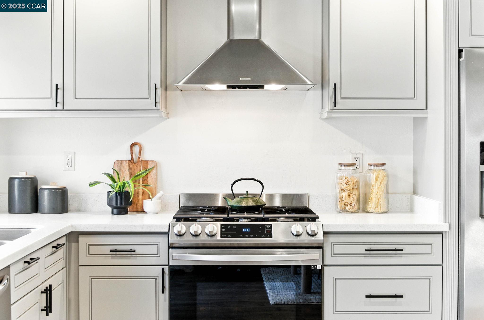 1660 San Luis Road Walnut Creek, CA 94597 - Photo 11 of 46 a kitchen with a stove and white cabinets