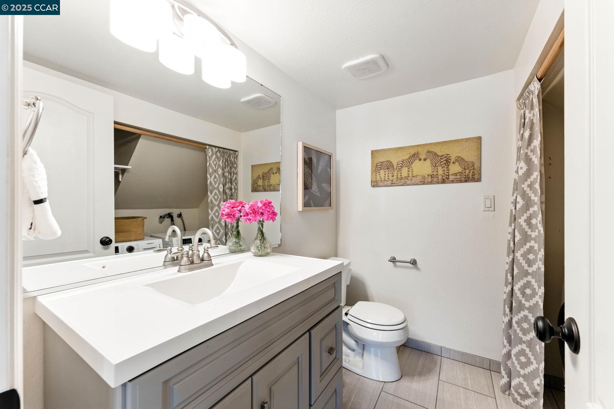 1660 San Luis Road Walnut Creek, CA 94597 - Photo 18 of 46 a bathroom with a sink vanity mirror and toilet