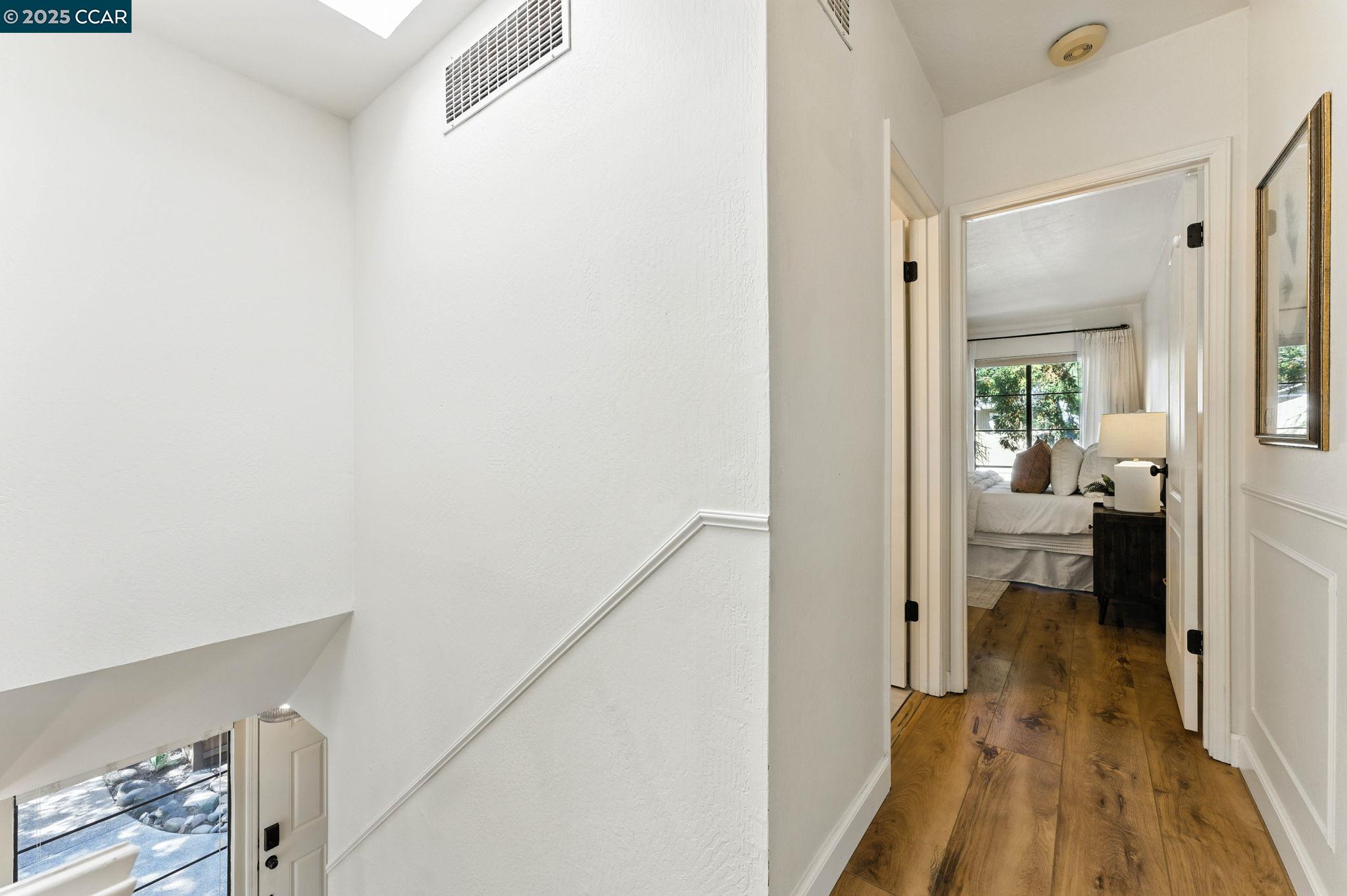 1660 San Luis Road Walnut Creek, CA 94597 - Photo 20 of 46 a view of a hallway with white walls and wooden floor
