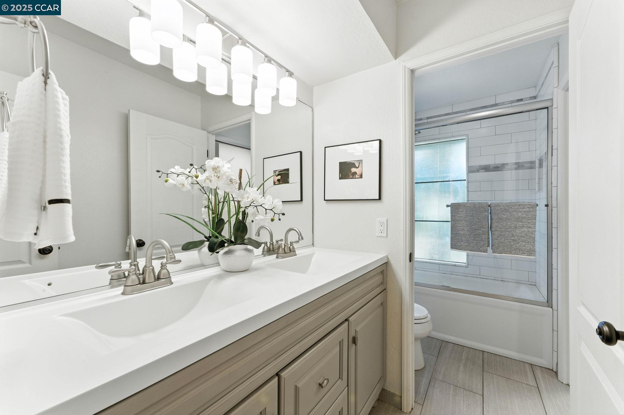 1660 San Luis Road Walnut Creek, CA 94597 - Photo 28 of 46 a bathroom with a sink a vanity and a mirror