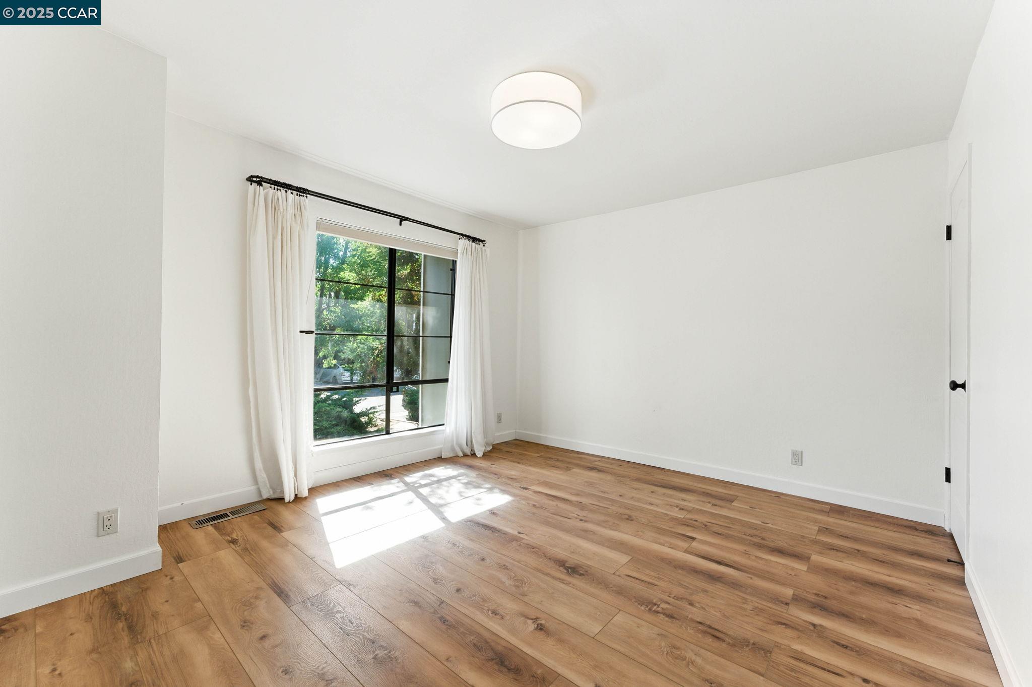 1660 San Luis Road Walnut Creek, CA 94597 - Photo 34 of 46 a view of an empty room with wooden floor and a window