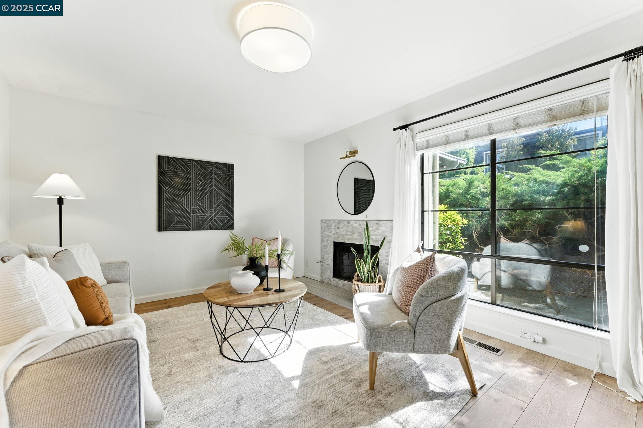 1660 San Luis Road Walnut Creek, CA 94597 - Photo 4 of 46 a living room with furniture a floor to ceiling window and a fireplace