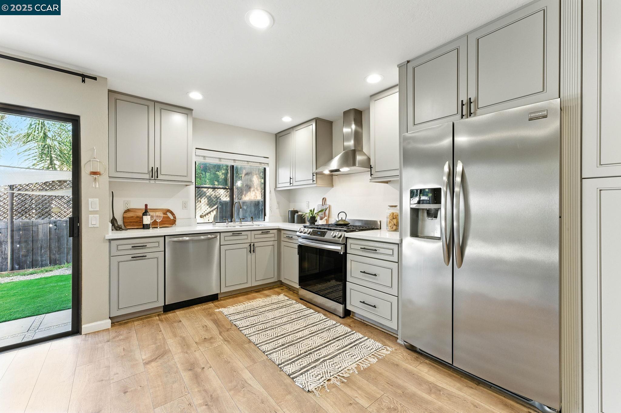 1660 San Luis Road Walnut Creek, CA 94597 - Photo 9 of 46 a kitchen with a refrigerator and a sink