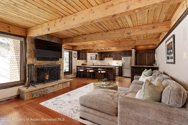a kitchen with granite countertop a table chairs stove and cabinets