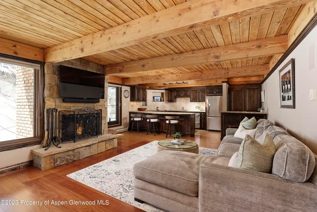 a kitchen with granite countertop a table chairs stove and cabinets