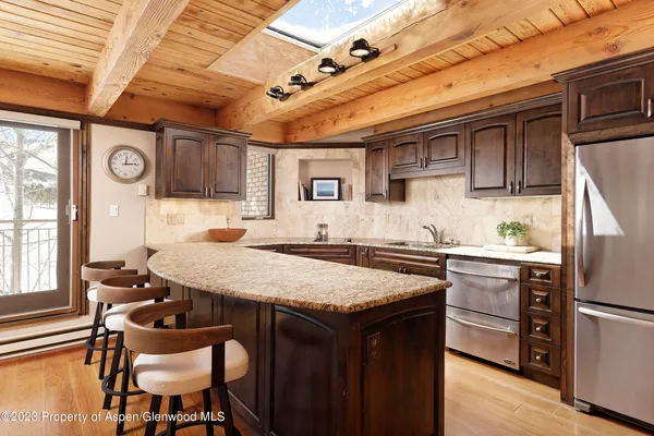 a dining table with chairs and wooden floor