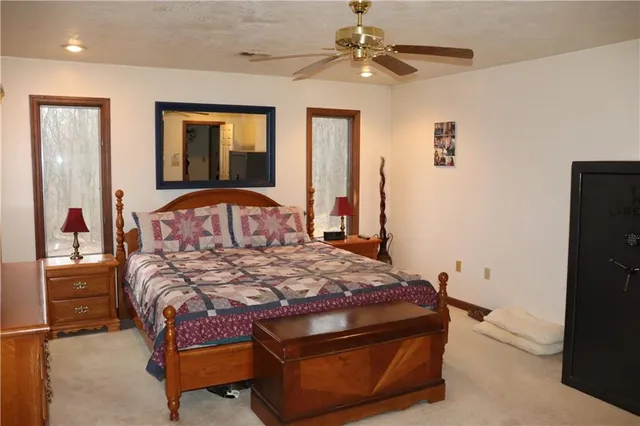 a bedroom with a bed a window and closet