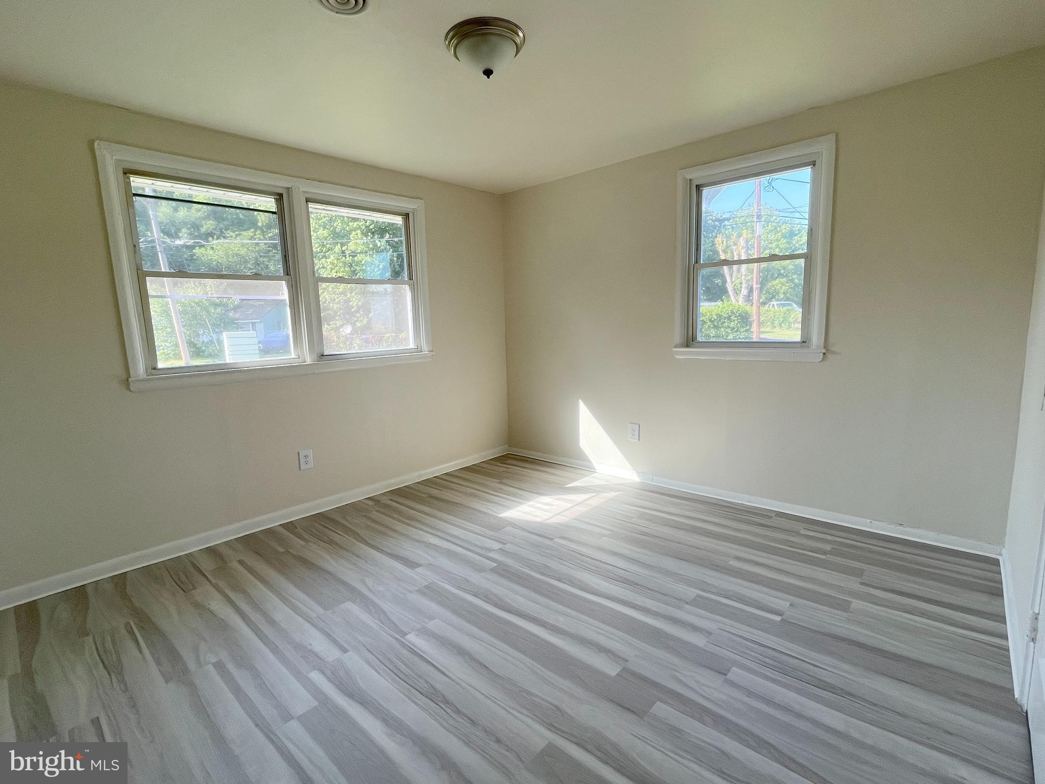 227 Kinsley Road Pemberton, NJ 08068 - Photo 12 of 18 a view of an empty room with wooden floor and a window
