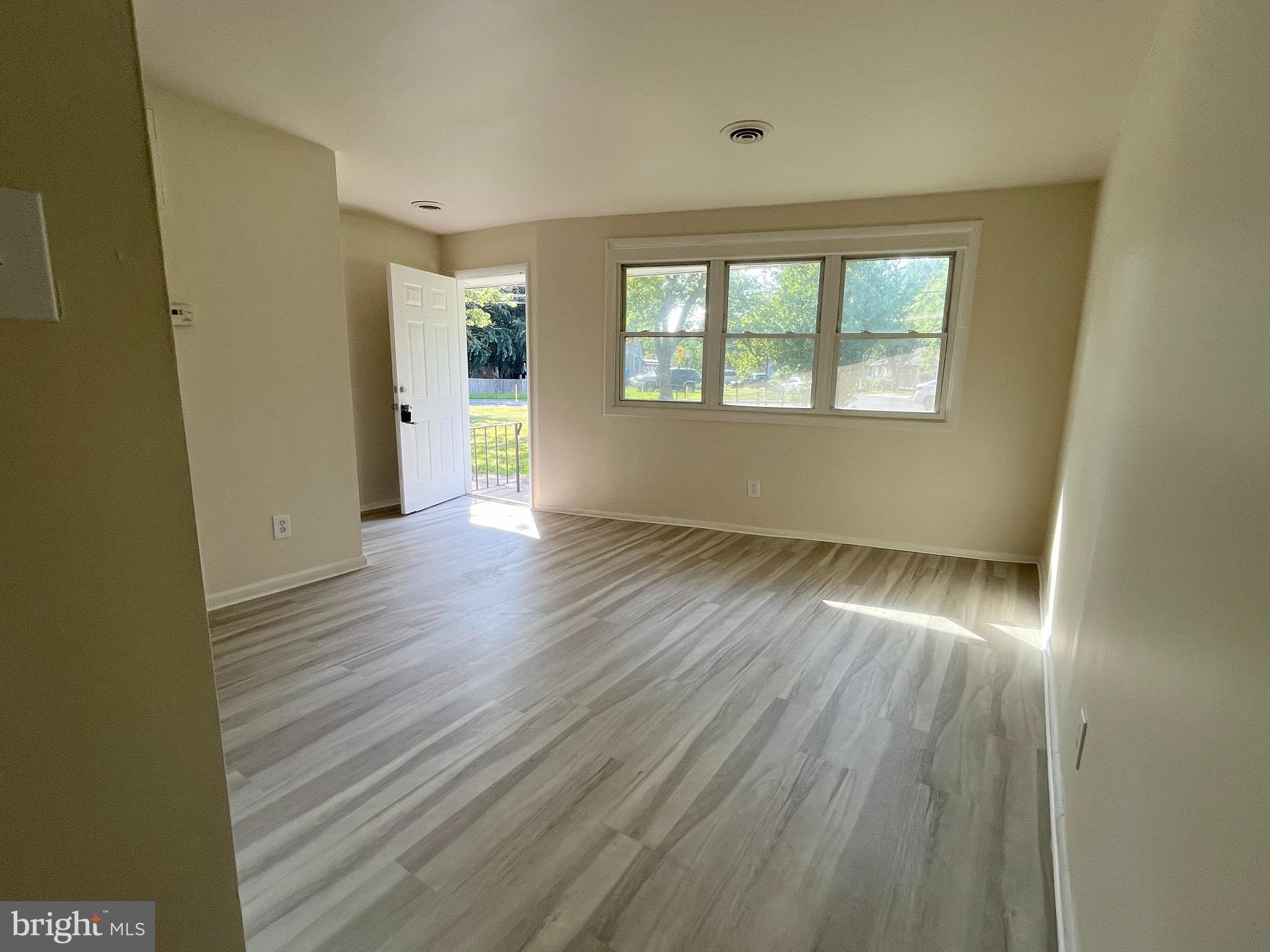 227 Kinsley Road Pemberton, NJ 08068 - Photo 13 of 18 an empty room with wooden floor and windows