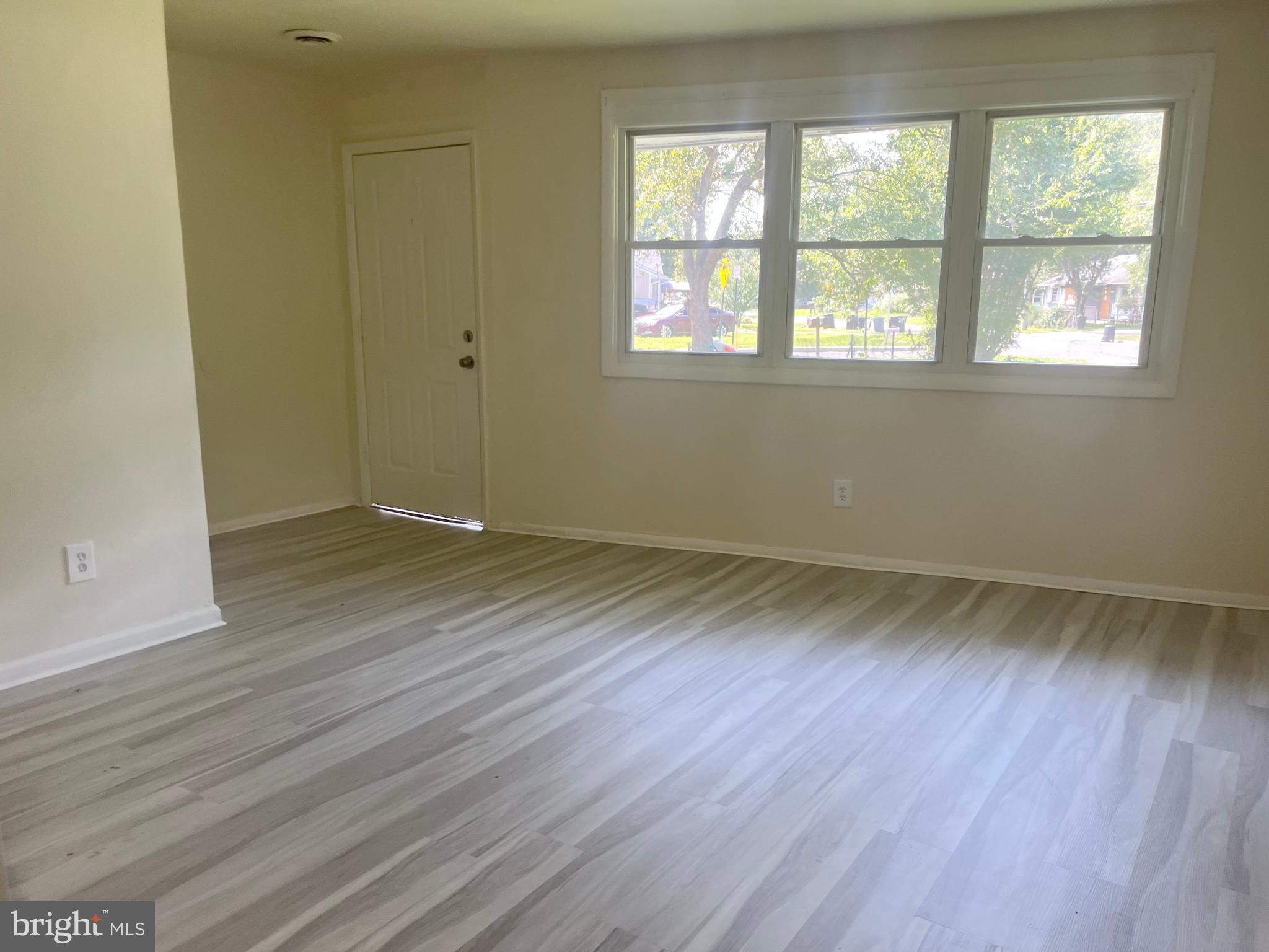 227 Kinsley Road Pemberton, NJ 08068 - Photo 14 of 18 an empty room with wooden floor and windows