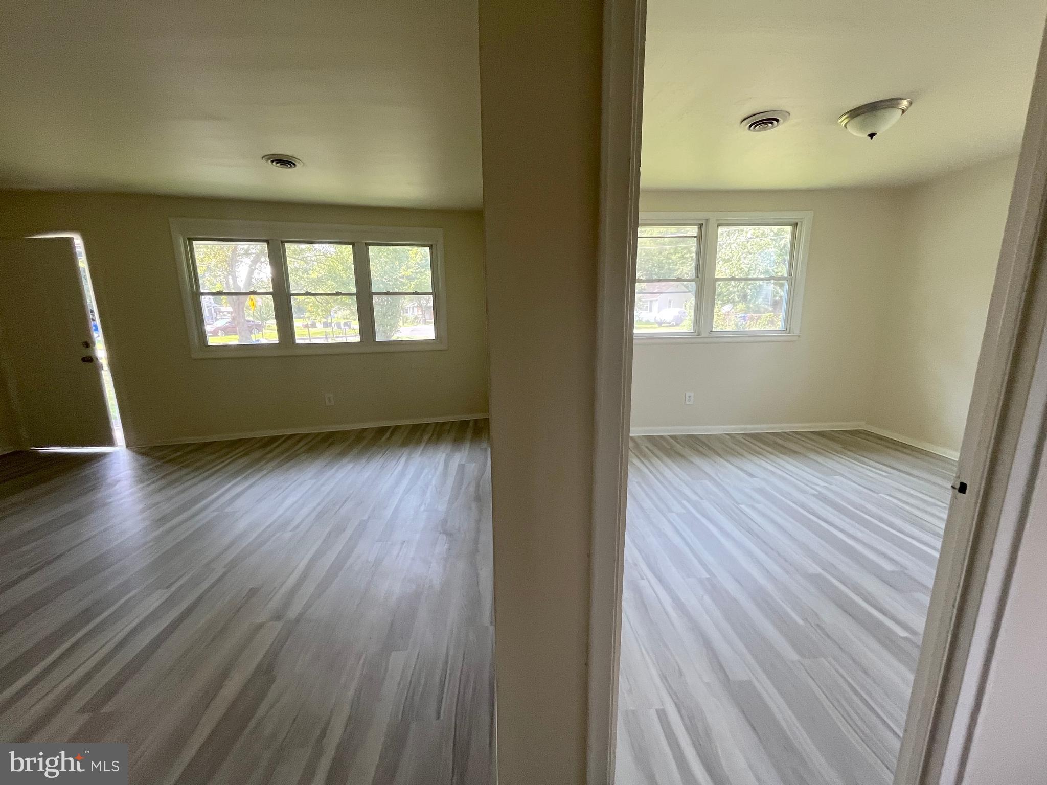 227 Kinsley Road Pemberton, NJ 08068 - Photo 15 of 18 an empty room with wooden floor and windows