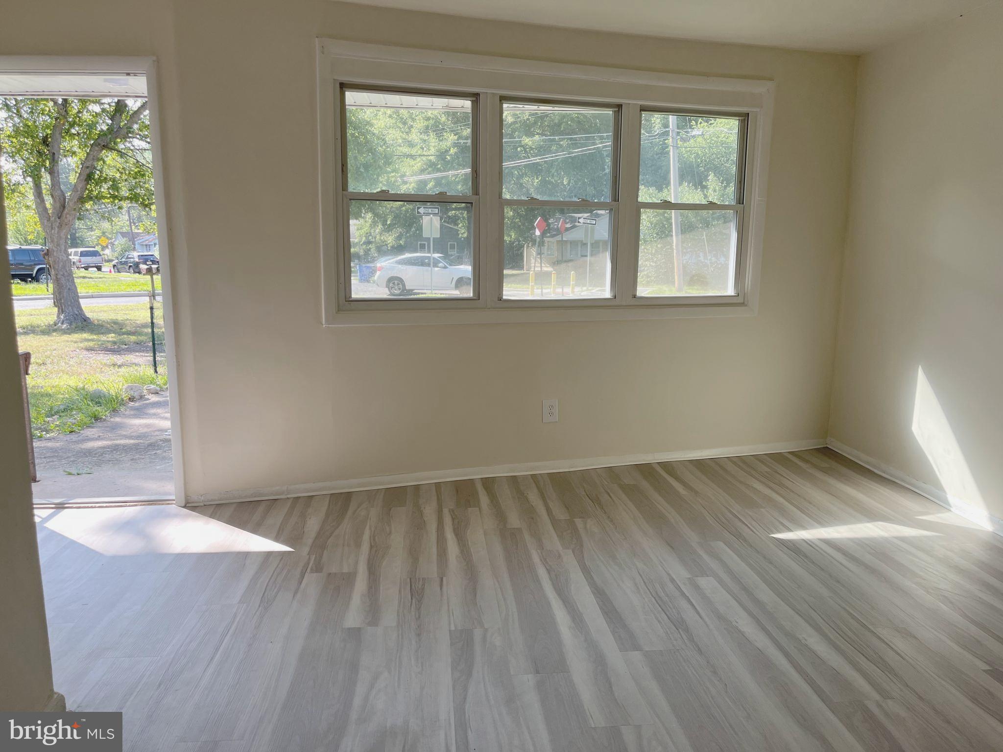 227 Kinsley Road Pemberton, NJ 08068 - Photo 3 of 18 an empty room with wooden floor and windows