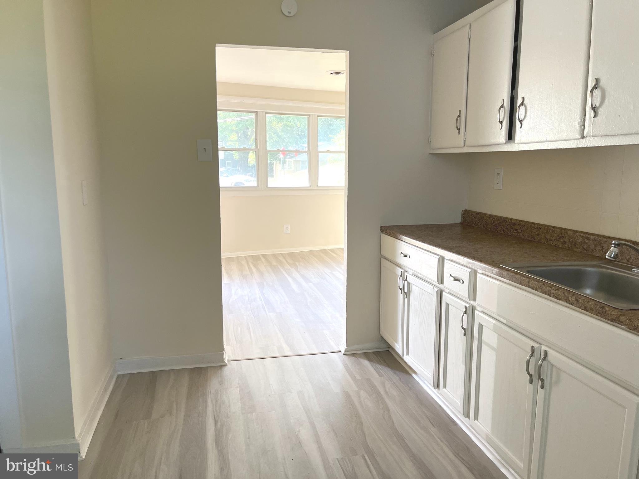 227 Kinsley Road Pemberton, NJ 08068 - Photo 7 of 18 a kitchen with granite countertop white cabinets and sink
