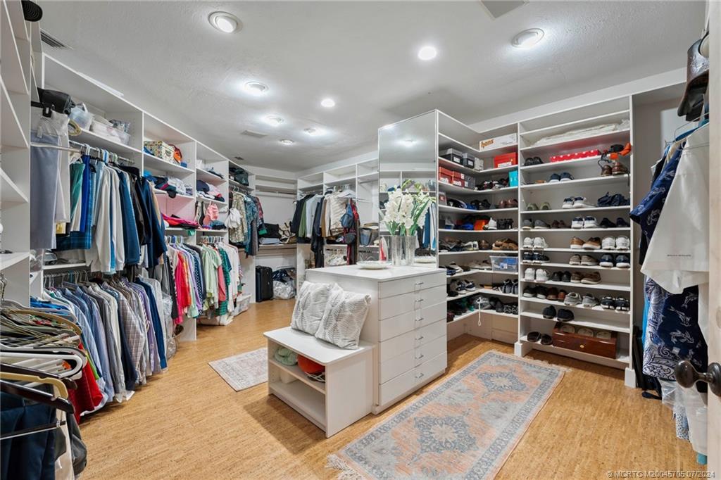 24 Ridgeland Drive Stuart, FL 34996 - Photo 53 of 99 a view of walk in closet with clothes and shoes
