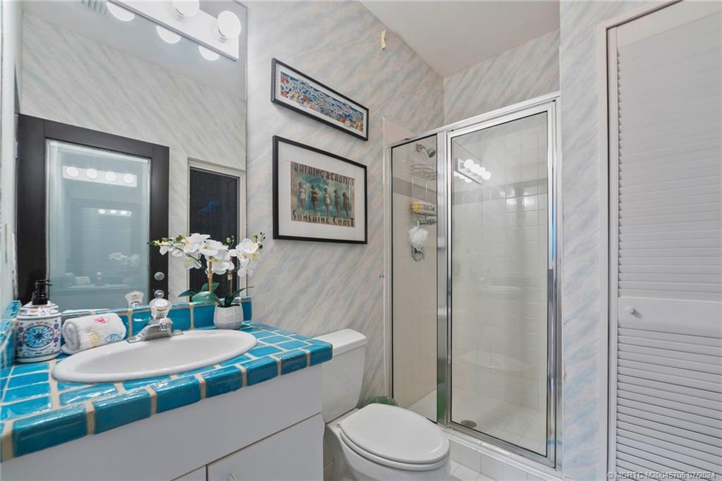 24 Ridgeland Drive Stuart, FL 34996 - Photo 78 of 99 a bathroom with a sink a toilet and shower
