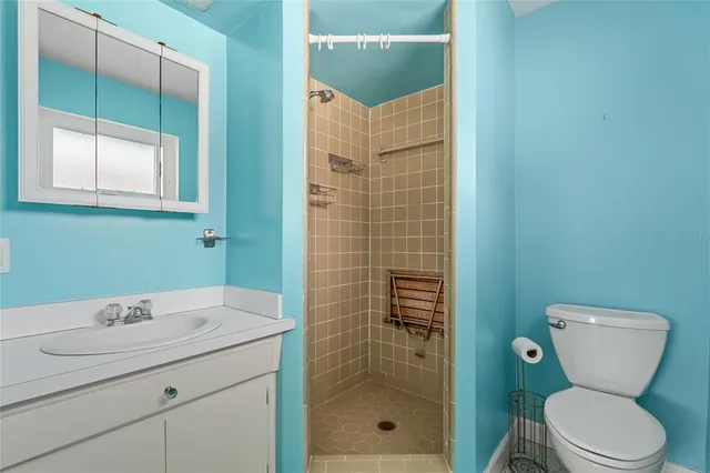 a bathroom with a toilet sink and shower
