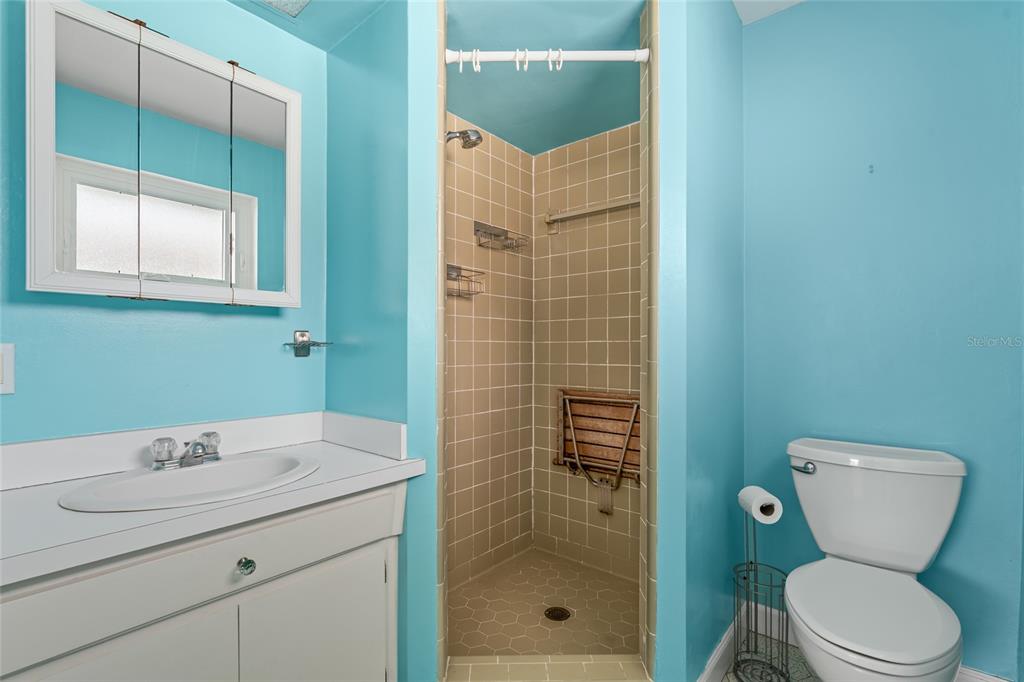 13236 84th Terrace Seminole, FL 33776 - Photo 11 of 34 a bathroom with a toilet sink and shower