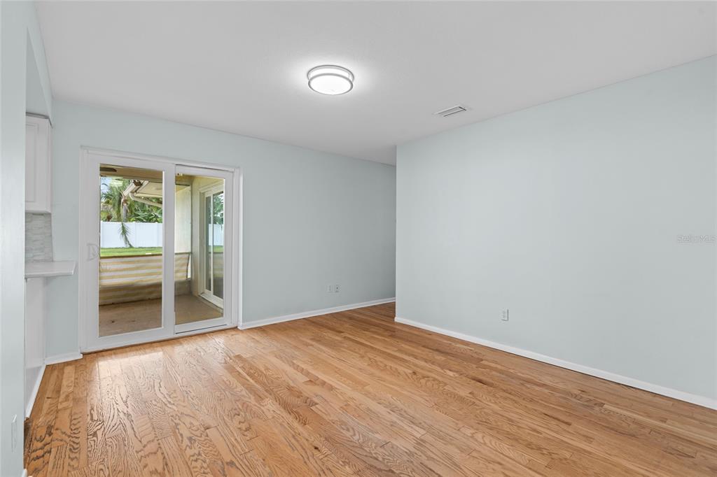 13236 84th Terrace Seminole, FL 33776 - Photo 16 of 34 an empty room with wooden floor and windows