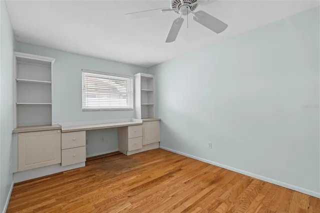 a view of a room with a wooden floor and white walls