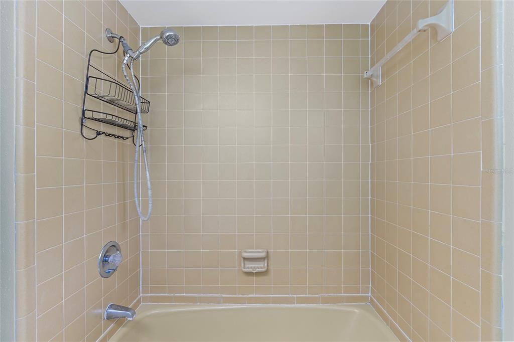 13236 84th Terrace Seminole, FL 33776 - Photo 21 of 34 a bathroom with a shower and a bathtub